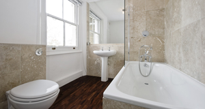White suite with warm wood-effect flooring